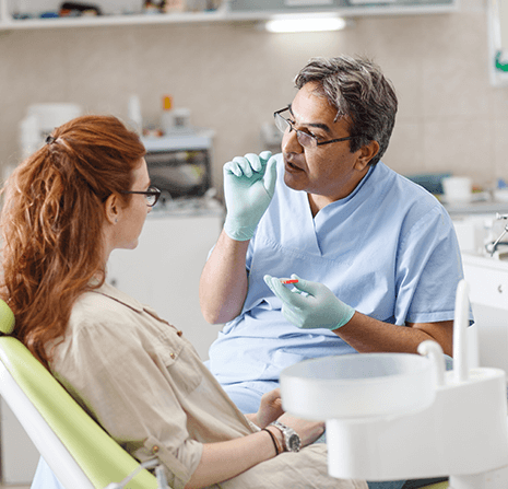 Dentist performing root canal procedure